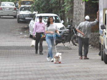 Sophie Choudry snapped taking her dog out for a walk