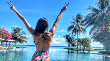 HOT: Disha Patani poses in a floral swimsuit against a serene backdrop