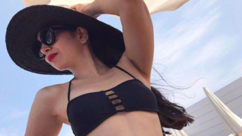 Karisma Kapoor looks smoking hot in this black two-piece swimwear and we can’t stop ogling