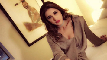 HOT! Nargis Fakhri sizzles in a brown dress with a plunging neck line