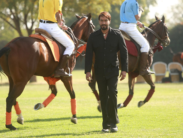Ajay Devgn walks between a live polo match for the song Mere Rashke Qamar