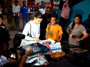 Deepika Padukone cuts a cake for a fan