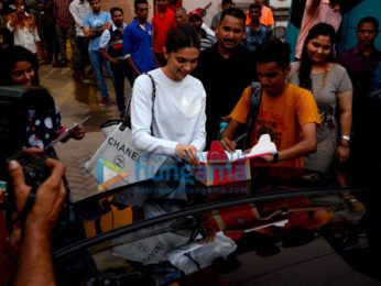 Deepika Padukone cuts a cake for a fan