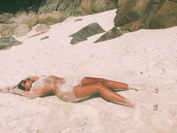 Mandana Karimi turns up the heat as she goes topless on the beach