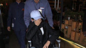A wheelchair-bound Irrfan Khan hides his face as the paparazzi spots him at the airport