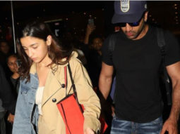 Ranbir Kapoor safely escorts Alia Bhatt from the crowd gathered at the airport