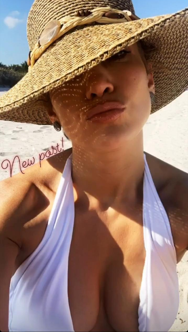 Jennifer Lopez soaks under the Miami sun flaunting her toned body in white halter-neck swimsuit 