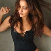 Neha Sharma sets the temperature soaring as she sizzles in a black monokoni