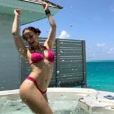 Elli AvRam poses in a pink bikini in a jacuzzi; says she is reliving her birth