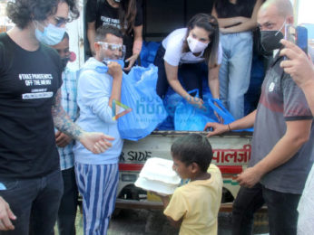 Sunny Leone and Daniel Weber snapped distributing food at Earth cafe in Bandra