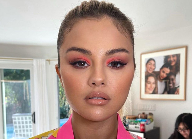 Selena Gomez makes a case for green manicure and neon coral eye makeup echoing the tropical weather