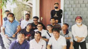Aamir Khan and Kiran Rao pose together with a group of people on sets of Laal Singh Chaddha in Kargil