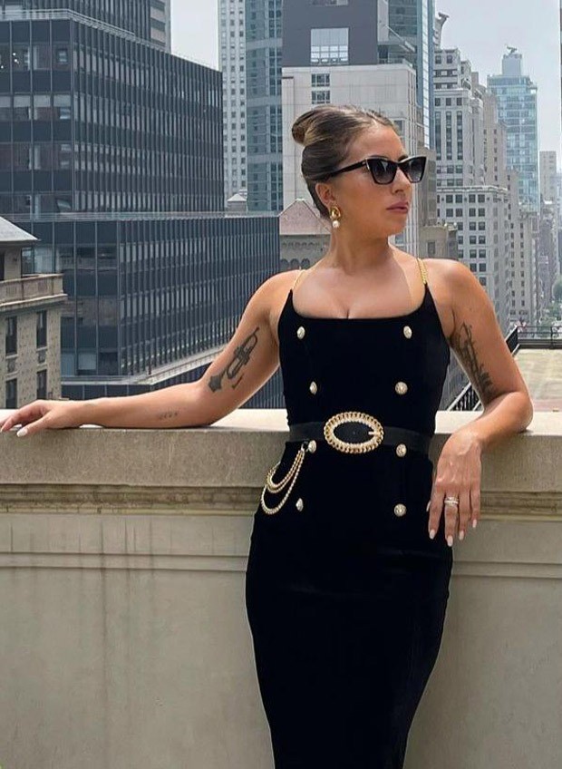 Lady Gaga makes a statement in a figure-hugging black outfit with gold details