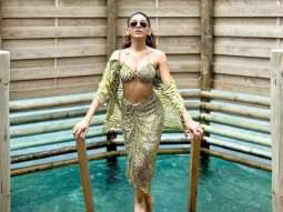 Alaya F turns up the heat in a sexy striped bikini top, matching wrap skirt and overlay in Maldives
