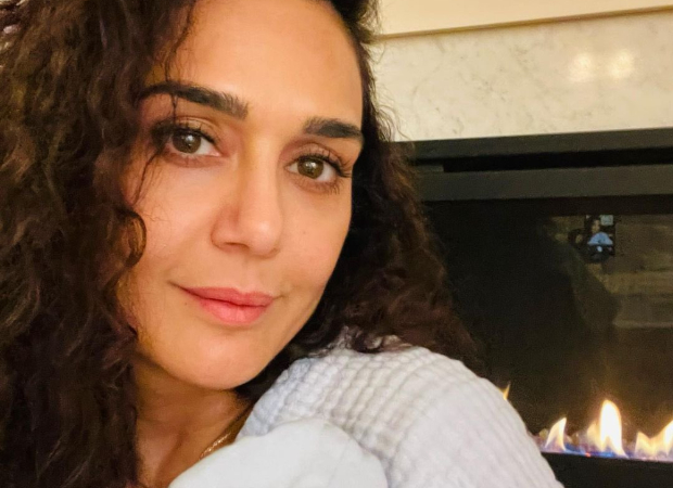 New mom Preity Zinta cuddles one of her twins in first picture of her newborn