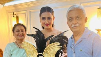 Bigg Boss 15 winner Tejasswi Prakash poses with her parents after lifting Bigg Boss 15 trophy