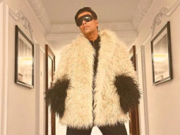 Karan Johar strikes a pose in a Gucci outfit paired with red boots; Farah Khan calls it Ostrich outfit, netizens agree
