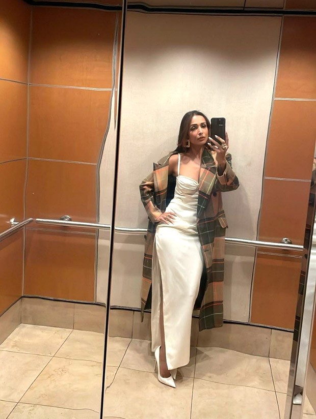 Malaika Arora is vision in pearl white strappy corset style thigh-high slit dress