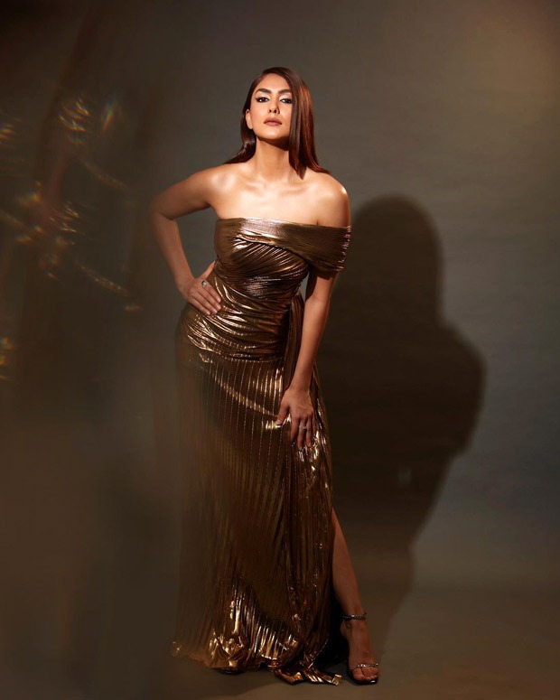 Mrunal Thakur exudes glamorous eminence in one-shoulder thigh-high slit gold metallic gown and fierce eyes 