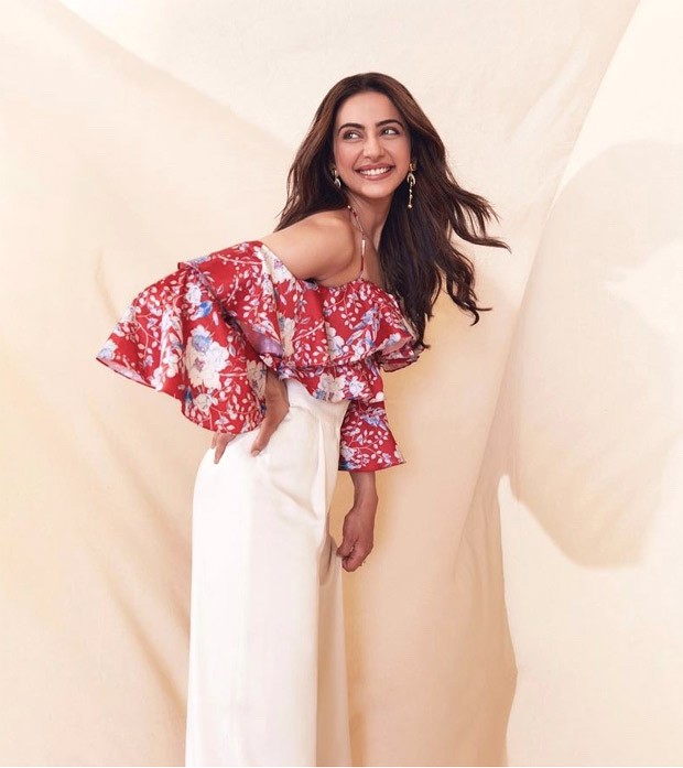 Rakul Preet Singh is giving major summer inspiration in easy-breezy printed cold shoulder ruffle top and ivory trouser worth Rs. 13,175 for Runway 34 promotions