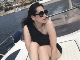 Karisma Kapoor is hotness overloaded in a sultry black off-shoulder monokini while soaking up the sun on a boat