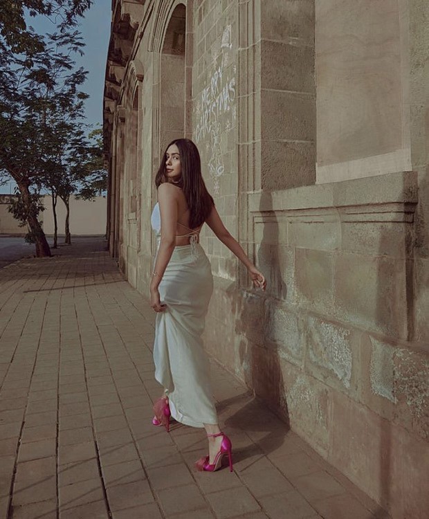 Mrunal Thakur looks pristine in white backless gown paired with Jimmy Choo fuchsia heels worth Rs. 69,545