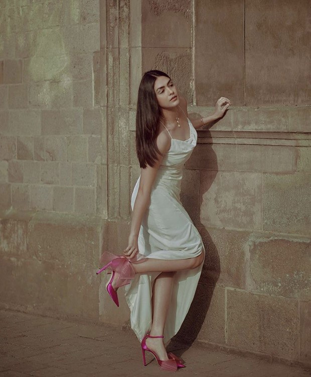 Mrunal Thakur looks pristine in white backless gown paired with Jimmy Choo fuchsia heels worth Rs. 69,545
