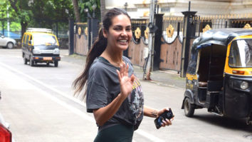 Esha Gupta waves as she poses for paps