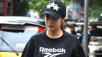 Malaika Arora poses to paparazzi as she returns home