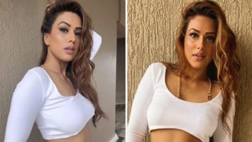 Nia Sharma poses on balcony in a micro-mini denim skirt and a crop top