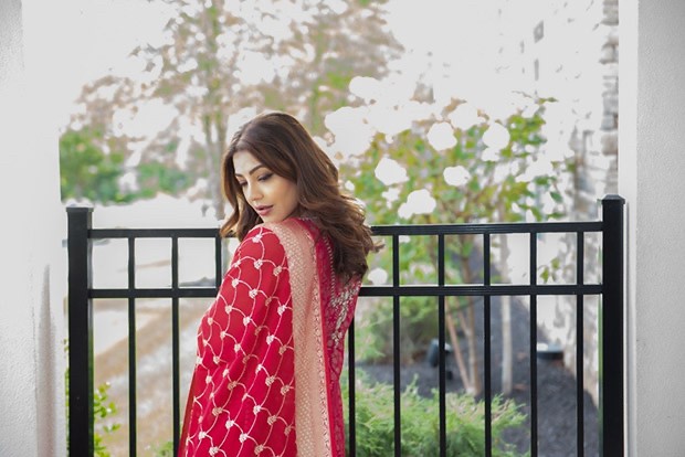 Kajal Aggarwal looks resplendent in a red Benarasi sharara set worth Rs. 1,20,000