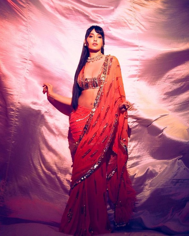 Nora Fatehi in Manish Malhotra’s orange sequined saree is setting screens ablaze Nora Fatehi in Manish Malhotra’s orange sequined saree is setting screens ablaze