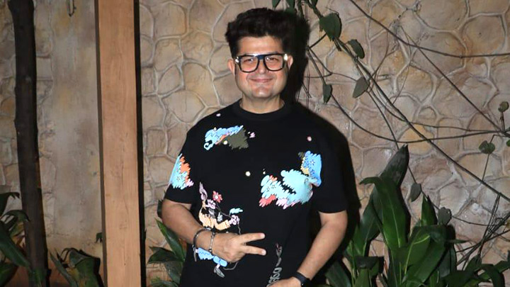 Dabboo Ratnani smiles as he poses for paps