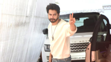 Varun Dhawan poses for paps in white sweatshirt and denims