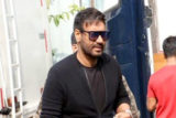 Ajay Devgn waves at paps in a black tshirt