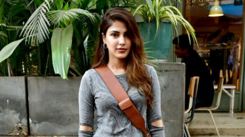 Rhea Chakraborty smiles as she poses for paps