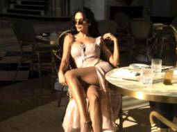 Esha Gupta spends a lovely sunny afternoon in Doha in a charming flowery strappy dress
