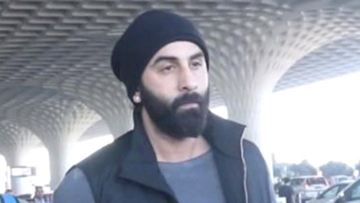 Ranbir Kapoor gets clicked at the airport sporting a black beanie as he poses with fans