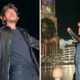 Shah Rukh Khan does his signature pose as the Pathaan trailer is screened on Burj Khalifa