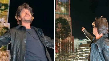 Shah Rukh Khan does his signature pose as the Pathaan trailer is screened on Burj Khalifa