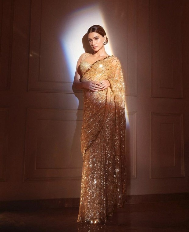 Kriti Sanon turns into the ultimate golden girl at Sidharth and Kiara's wedding reception wearing a golden sheer saree by Manish Malhotra