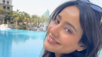 Neha Sharma has a wide smile spread across her face as she enjoys her pool time