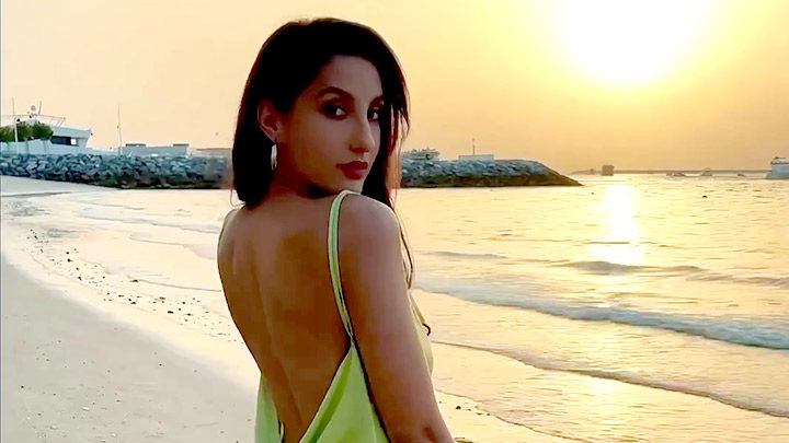 Nora Fatehi kills it with her perfect curves and a beautiful green satin dress