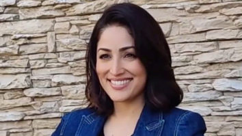 Yami Gautam poses for paps holding a poster with meaningful message