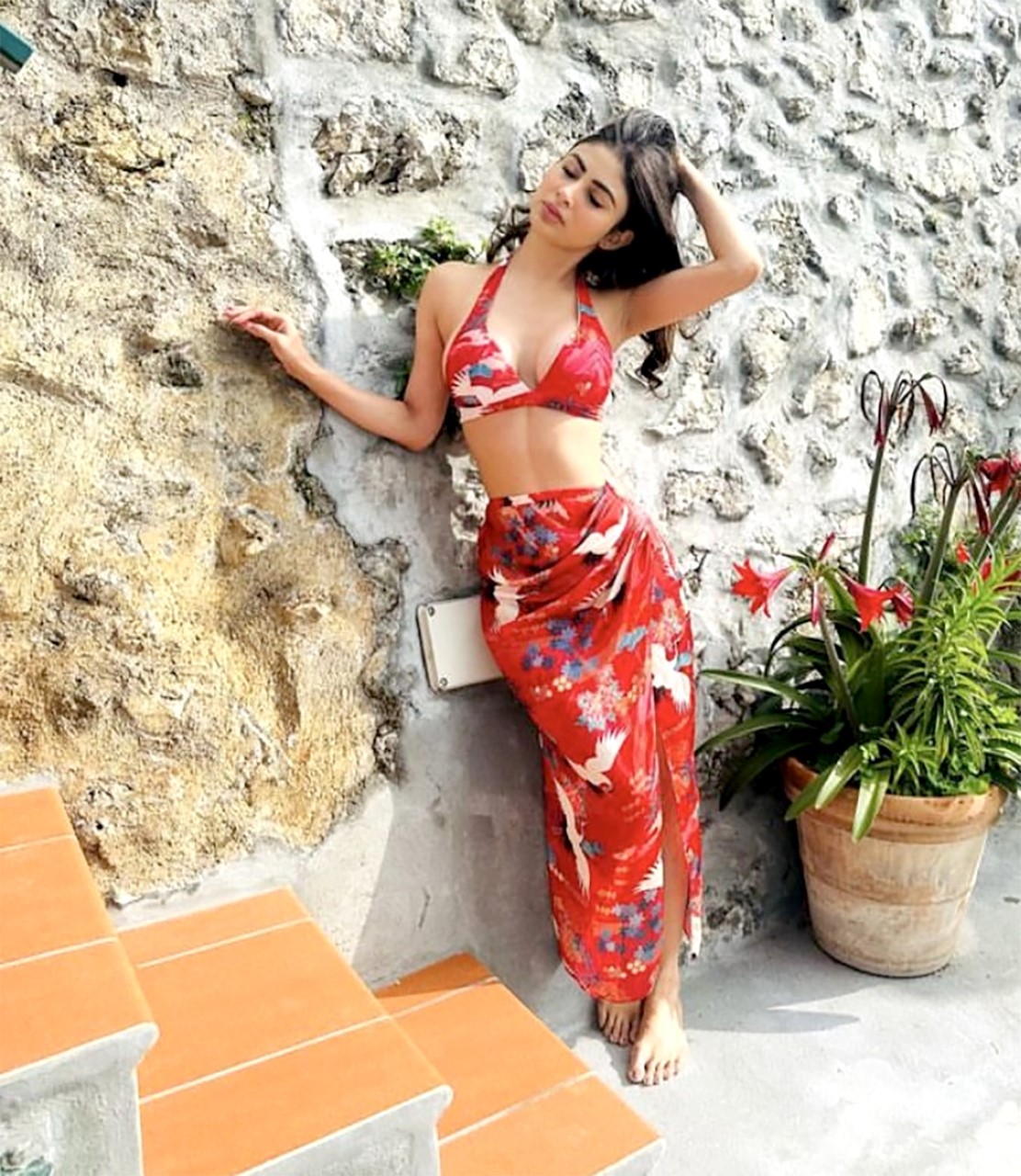 Mouni Roy blooms in her mesmerizing red sarong and bikini, adding a touch of paradise to her vacation style