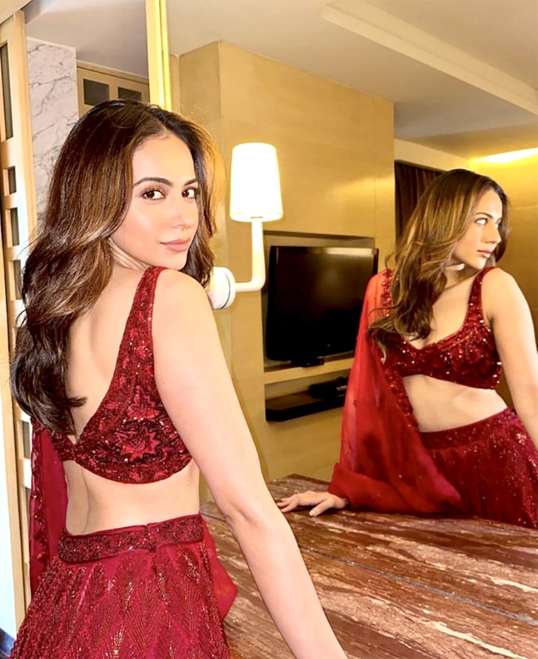 Rakul Preet Singh dazzles in a shimmery red lehenga, redefining elegance