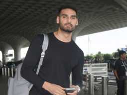 Ahan Shetty takes off his mask to pose for paps at the airport
