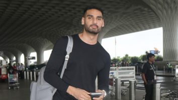 Ahan Shetty takes off his mask to pose for paps at the airport