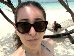 Karisma Kapoor enjoys summer sun in a blue bikini at the beach, sister Kareena Kapoor Khan ‘scrolls’ through her phone in background