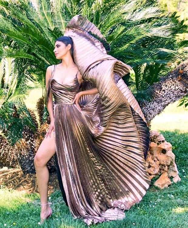 Mouni Roy gives us a hefty dose of glam in a stunning metallic dress that features multiple pleats and a daring side slit